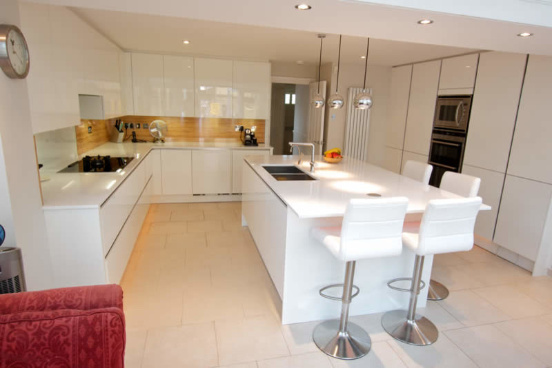 white glossy kitchen islands with handleless units and seat for 4