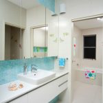 Chic And Modern Bathroom Idea With White Ceramic Tiles Floors Blue Tiles Walls & Backsplash Modern White Vanity And Planted Sinks Frameless Mirror White Bathtub