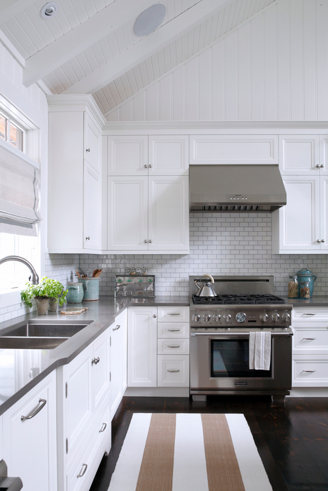 grey quartz countertop white kitchen dark floor stove wall tile cabinets faucet sink window white ceiling