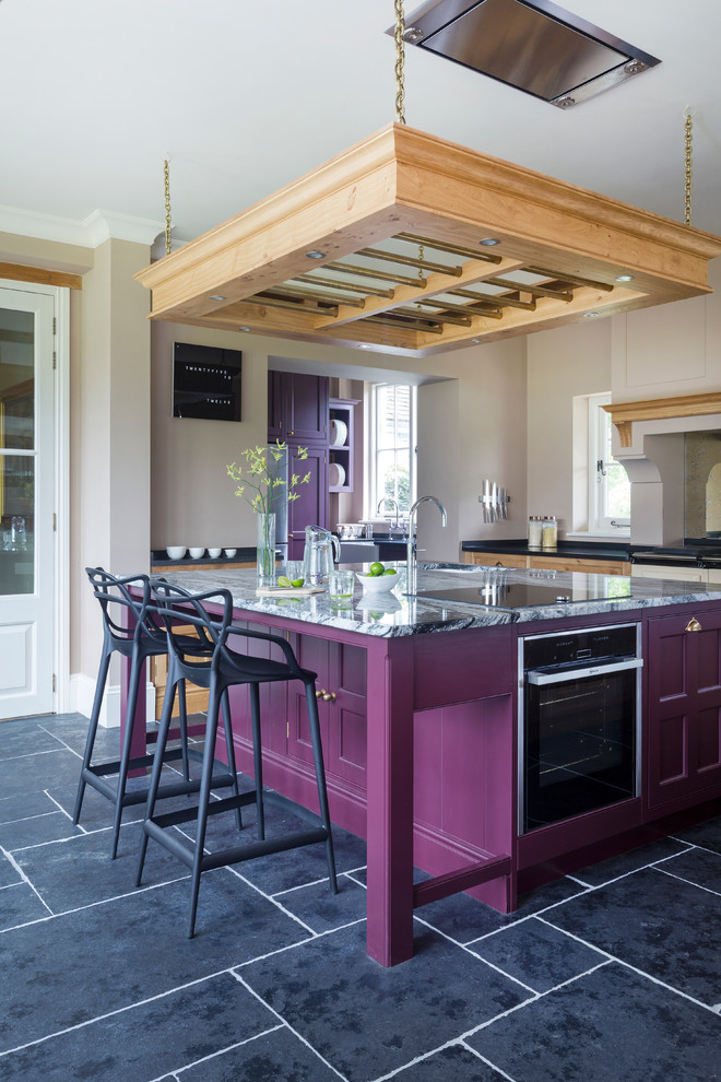 hand made transitional kitchen with hand painted kitchen island in purple and grey marble top stainless steel appliances ceiling hung wooden pot black ceramic floors black stools