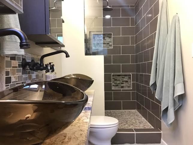 long small master bathroom with shower area, toilet, two sinks