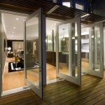 modern pivot glass patio doors with white wooden frame