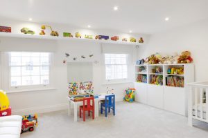 room decor with toy toys wall decor shelves small chairs table windows ceiling lamp kids room dolls books decoration