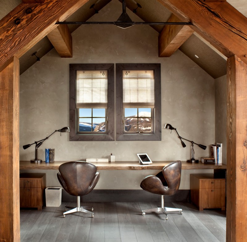 rustic office in the attic with brown leather swivel chair, wooden table