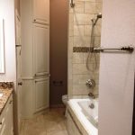 soft brown small master bathroom with toilet in the separated room