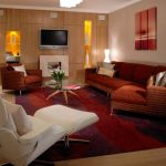 tv display decoration carpet wood floor sofa pillows light warm lighting wall storage glass top table