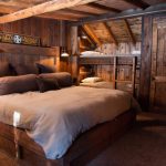guest bed ideas brown pillows lamps ladder small beds stones wooden walls rustic bedroom