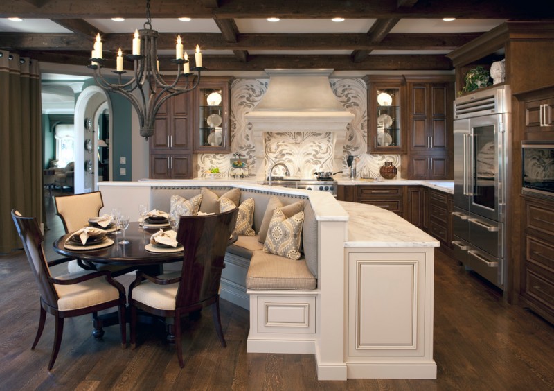 kitchen with cream banquette area, cream counter top, brown wooden cabinet, whtie grey mosaic backsplash and hood