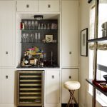 Small Bar In The Kitchen Cabinet With Black Marble Top, Glass Shelves On Top