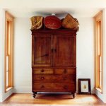 Traditional Wood Cupboard In Dark Toned Wood Color Medium Toned Wood Floors Clean White Walls White Siding Wood Ceiling