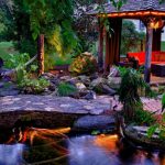 Tropical Landscape Yard With Gazebo, Red Sofa, Stone Bridge, Lightings Under The Plants