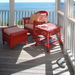 apartment balcony furniture wood floor railing red furniture pieces scenery traditional outdoor area