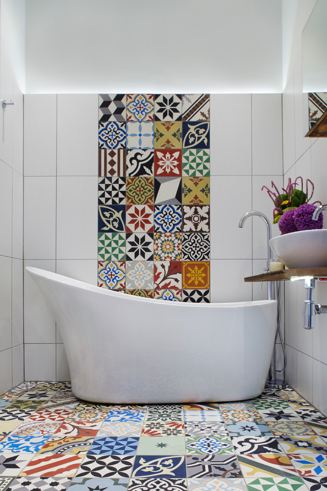 bathroom color trends vessel sink wood countertops freestanding tub multicolored tiles stone floor faucets mirror shower mediterranean design