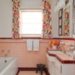 Orange Ceramic Walls For Base And White Concrete Walls For Top Multicolored Window Curtains White Bathtub Wall Mounted Bathroom Vanity With Orange Countertop And White Sink And White Cabi