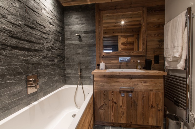 rustic bathroom towel warmer walk in shower tub combo wood cabinet stone wall traditional mirror