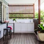 viking outdoor kitchen wooden floor stools white cabinets faucets sink fence plant pot windows contemporary style