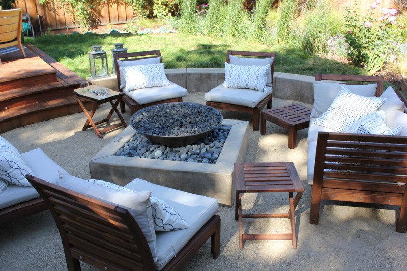 backyard patio with a fire feature and decomposite granite sand floor deck wooden floor IKEA chair sets white pillow throws