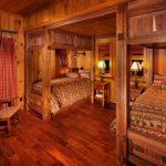 cabin designs and floor plans wood floor beds small tables lamps rocking chair windows curtain rustic bedroom