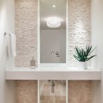 Stone Wall Floating Vanity Built In Sink Pendant Light Recessed Lights Tiled Wooden Floor Floor To Ceiling Mirror Flower Arrangement