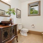 Black Vanities With Golden Carving, Wooden Countertop, Vessel Sink, Mirror, Limestone Floor, Toilet