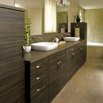laminate vanity brown cabinet double vanity sink beige tiled wall porcelain floor built in tub bathroom lamps towel holder