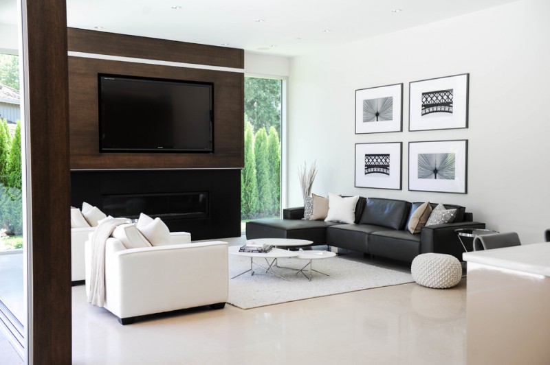 contemporary living room idea black leather sofa with decorative pillows white leather sofa with white accent pillows white area rug white floors large wood media wall modern black fireplace