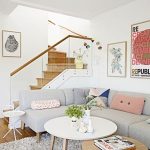 Living Room Near The Stairs, With Grey Corner Sofa With Soft Coloured Pillows, White Rug, White And Brown Round Coffee Tables