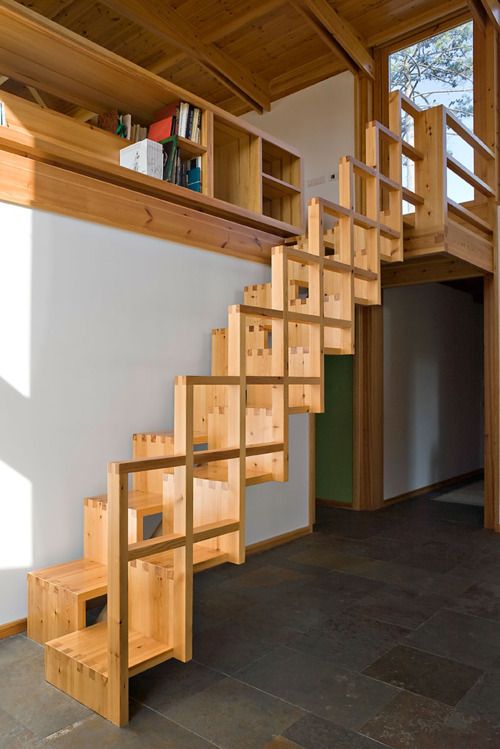 wooden stairs zigzag in small space with squares handrails 