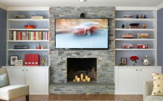 fireplace candle ideas stacked stones wall white built in cabinets and shelves wooden floor area rug tv unit chair sofa pillows