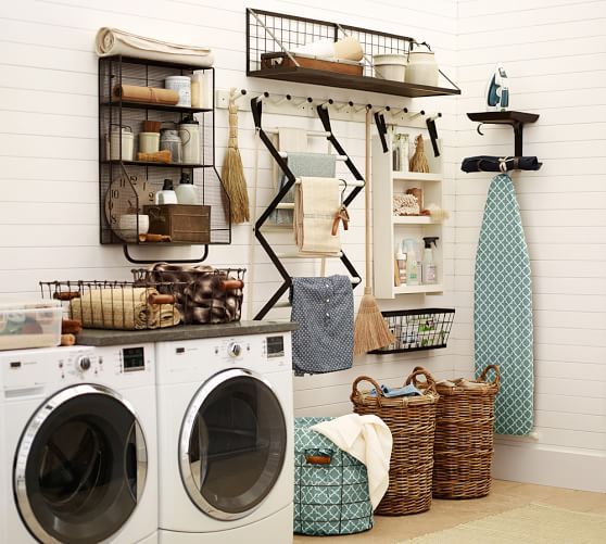 laundry room with two machines, rattan baskets, drying racks, shelves, ironing table