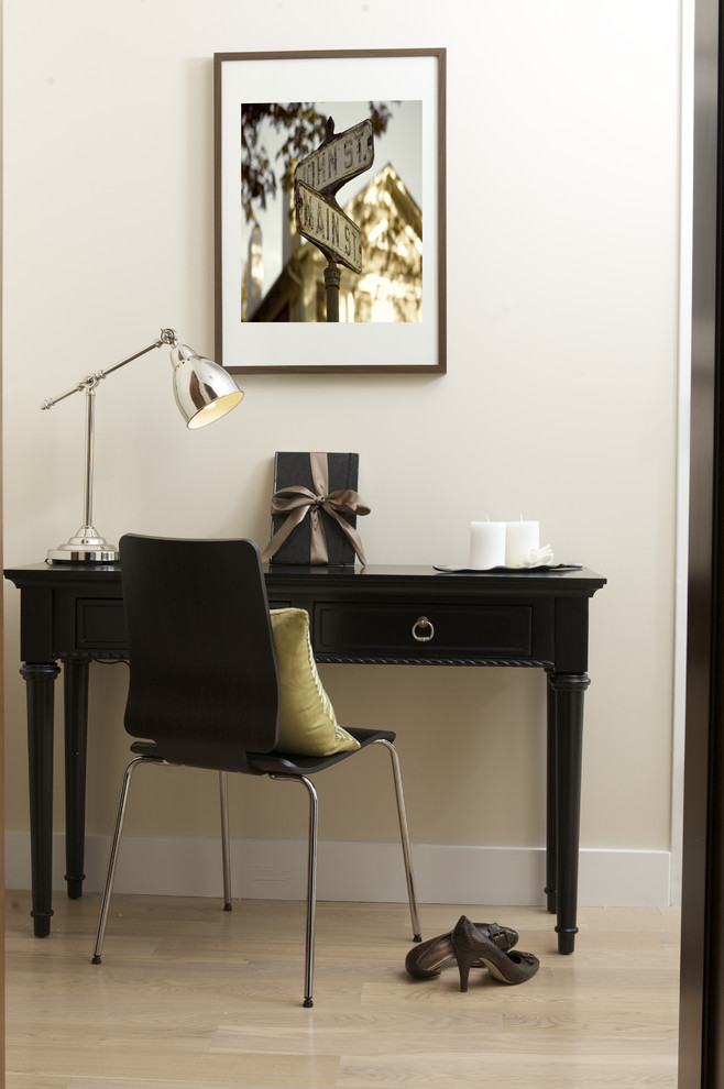 small writing desk with drawers black wooden desk modern black chair chrome table lamp light wooden flooring beige wall artwork
