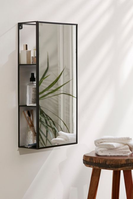 mirror with thin frame, shelves behind