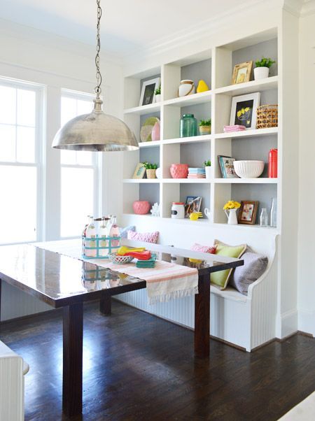 white wooden bench on dining nook with shelves built in with the bench, wooden table