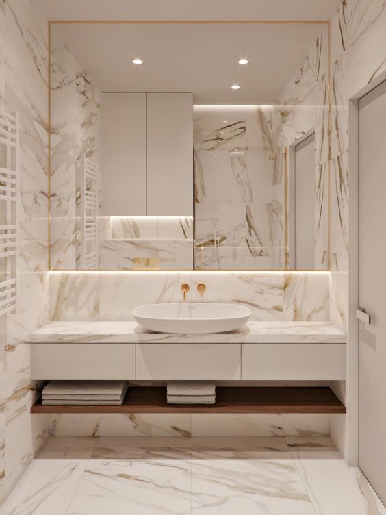 bathroom, marble tiles floor, wall, backsplash, white drawers with marble top, white sink, mirrors, wooden shelf