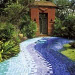 Blue Gradation Tiny Mosaic Tiles On The Pathway With Plants And Garden Pool On The Side