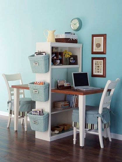 kids study space face to face with shelves in the middle, wooden small table, white wooden chairs with blue cover, blue basket on side