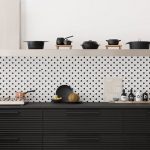 Kitchen With Black Cabinet, Tiny Black White Backsplash Tiles, Grey Floating Shelves
