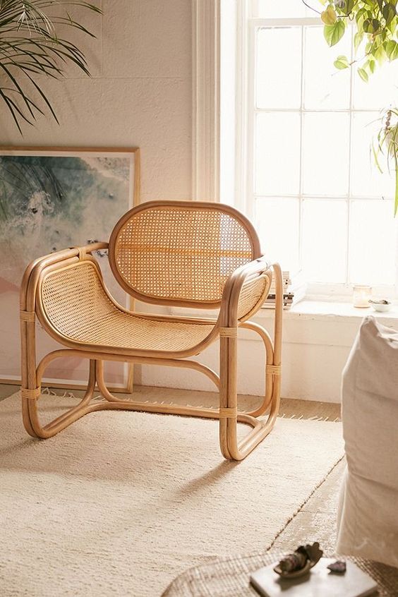 rattan chair with pattern on back, curvy on the seating, square legs