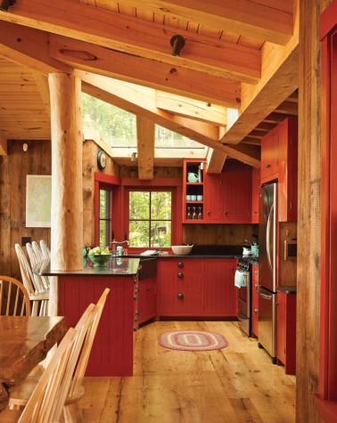 rustic kitchen, wooden floor, red cabinets, red framed window, black counter top