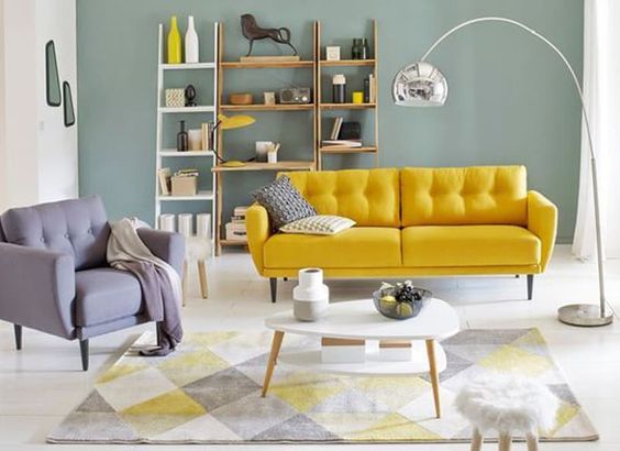 living room, white wooden floor, green wall, yellow sofa, grey chair, silver curvy floor lamp, shelves, white coffee table
