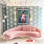 Pink Velvet Curvy Sofa With Metal Legs, Pink Pillows, White Rug, White Coffee Table, Accent Wall, Statement Ceiling, Sconce, Pendant