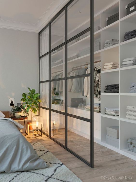 walking closet in the bedroom, wooden flor, white shelves, glass partition with curtain