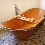 Wooden Boat Shaped Baht Tub With Wooden Board Across, On Marble Floor