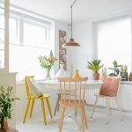 Dining Room, White Wooden Floor, White Wooden Round Table, Pink, Peach, White, Yellow Chairs, Brown Pendant, Whtie Wall And Ceiling
