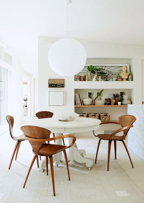 lean wooden chairs, white round table, white floor, white wall, white ceiling