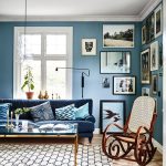 Living Room, Wooden Floor, Blue Wall, White Ceiling, Glass Pendant, Blue Sofa, Wooden Rocking Chair, White Rug, Glass Top Coffee Table