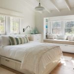 Window Seats White Wall White Vaulted Ceiling White Nightstands White Drawer Bench White Bedding Pillows Wall Sconces Windows White Window Shade