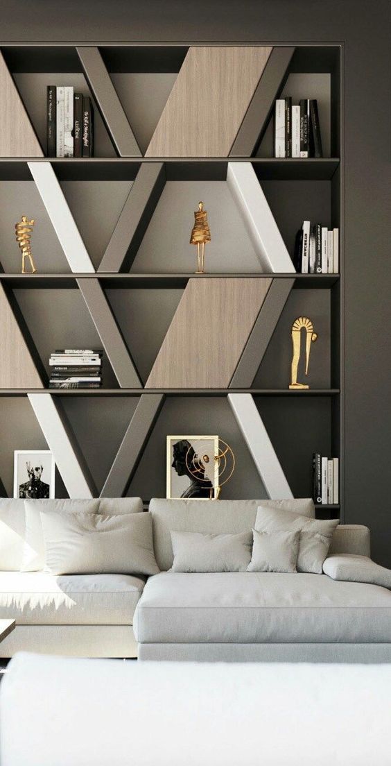 built in shelves with geometrical boxes, dark grey wall, white sofa