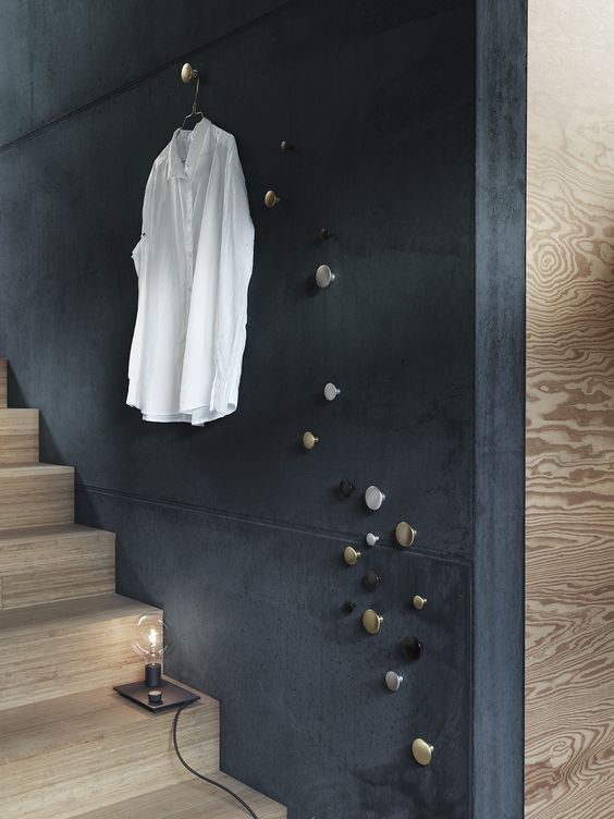 dark blue wall on the stairs, wooden stairs, metallic pins