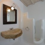 Greek Bathroom, White Plaster Wall And Floor, Floating Stone Sink, Mirror, Indented Wall, Wooden Ceiling, Grey Rug